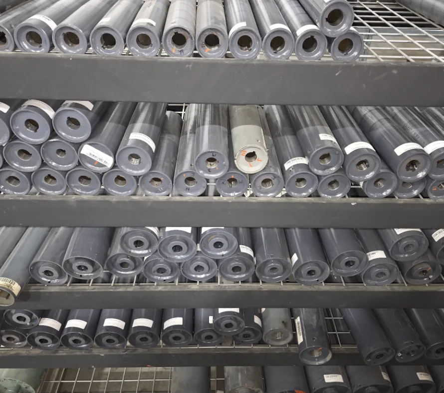 Shelves of conveyor rollers and pulleys in stock